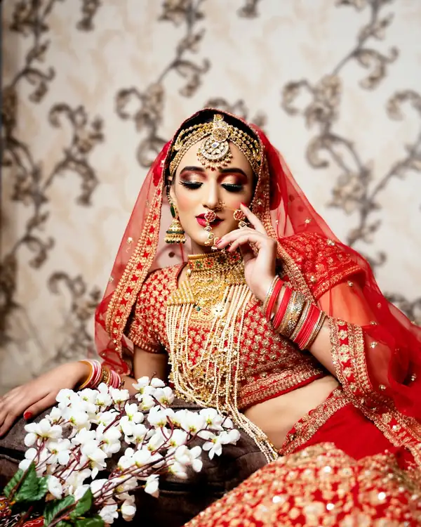 Bridal make-up, red and gold, holding a bouquet